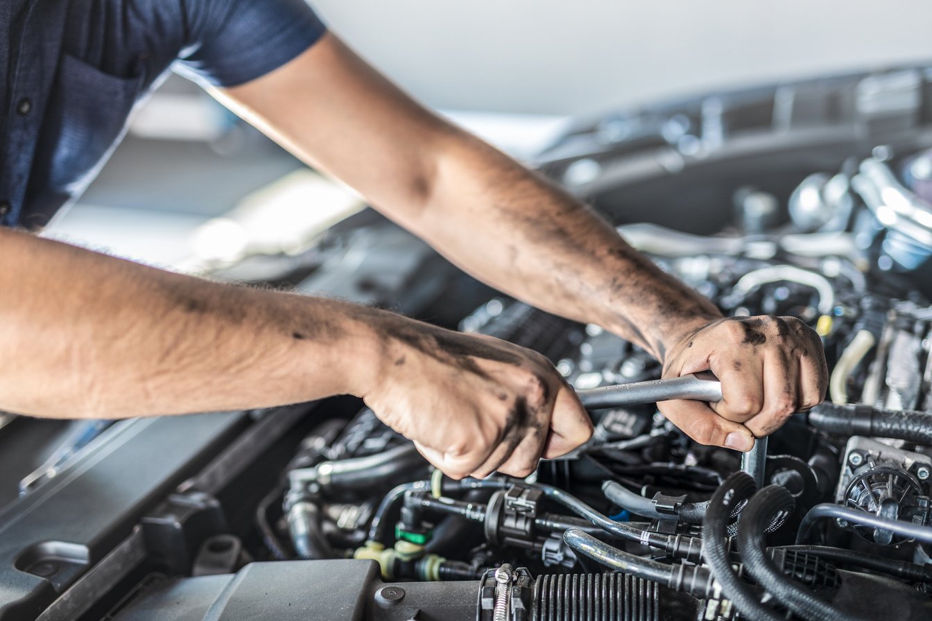 Auto Mechanic Working on Car Engine